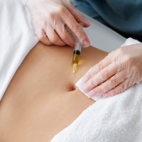 high-angle-healthcare-professional-injecting-belly_23-2149404725